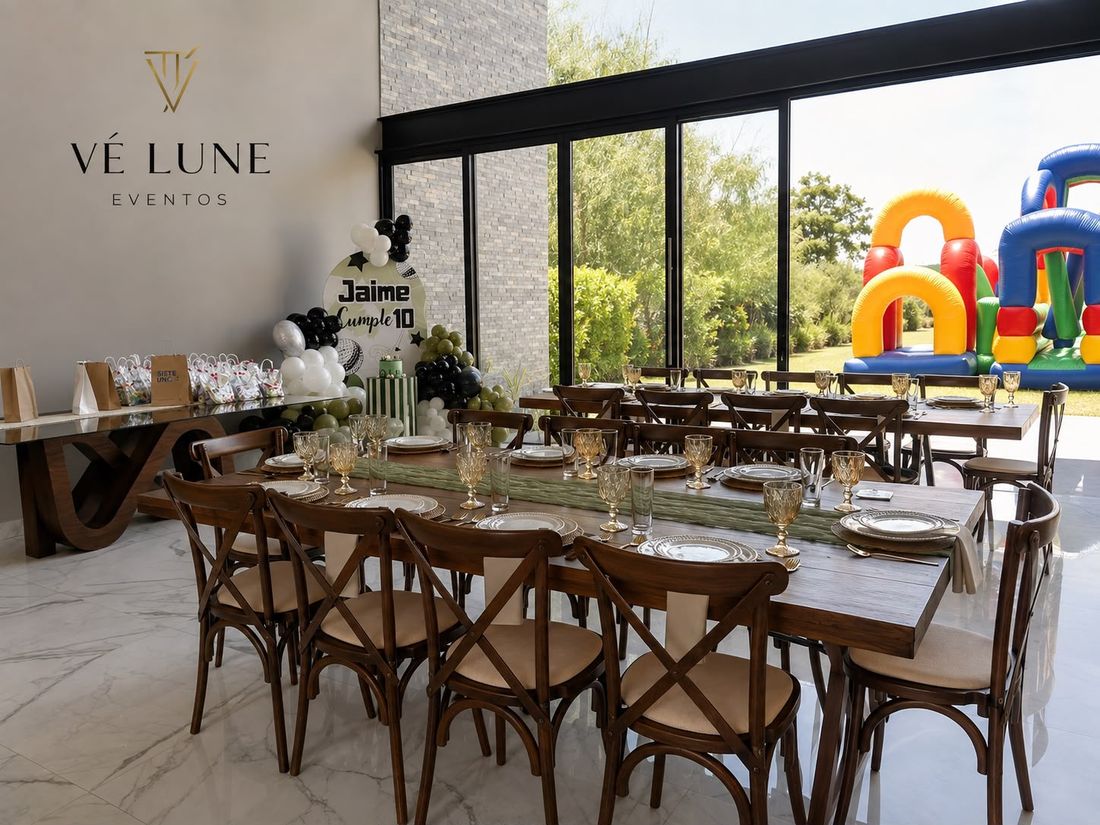 Salón de Vé Lune con ventanal, mesa larga montada y sillas Crossback